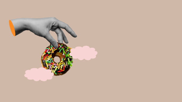 istock A hand is reaching for a donut with sprinkles on it 2171261722