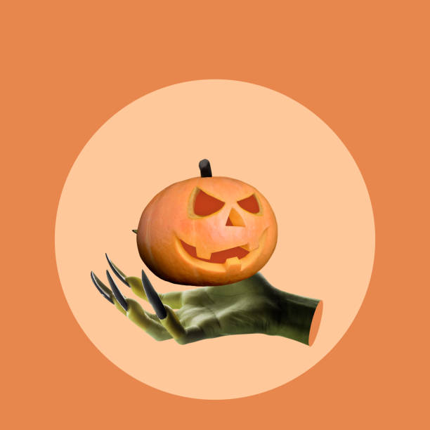 istock Witch hand holding a Halloween Jack o Lantern pumpkin with a scary face 2171263723