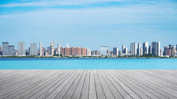 istock Empty wooden terrace and modern urban skyline with blue sky background 2171266206