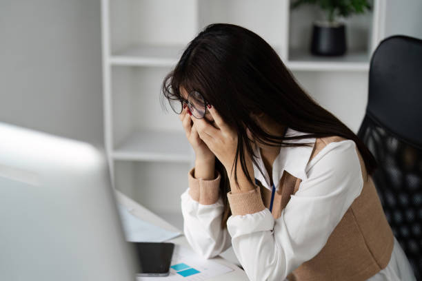 istock Stressed Office Worker Experiencing Office Syndrome at Desk with Computer and Documents 2171267650