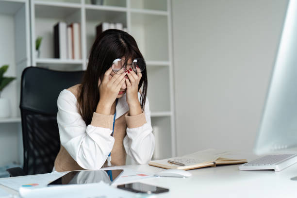 istock Stressed Office Worker Experiencing Office Syndrome at Desk with Computer and Documents in Modern Workspace 2171267661