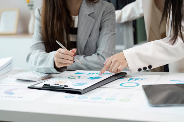 istock Business Professionals Collaborating on Financial Reports and Data Analysis in Modern Office Setting 2171268186