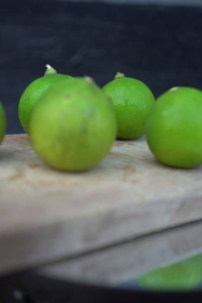 istock Fresh limes on a wooden cutting board 2171271039
