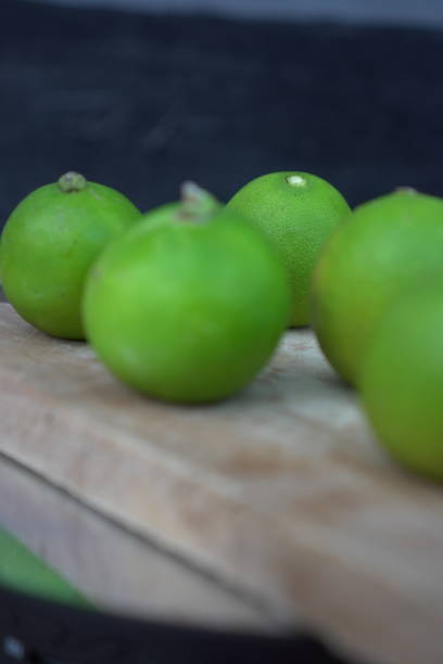 istock Fresh limes on a wooden cutting board 2171271073