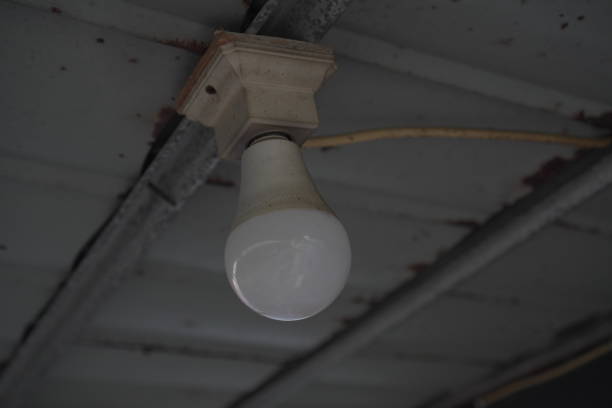 white Outdoor LED light bulbs installed in rusty asbestos canopy ceiling