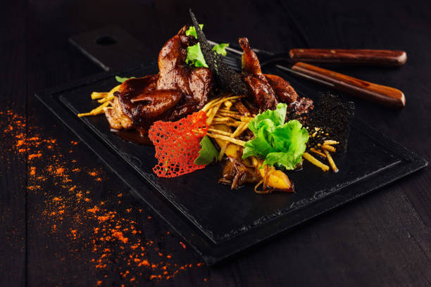 istock Grilled quails served on stone plate with potatoes and mushrooms 2171273747