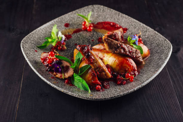istock Roasted duck breast with pear and red currant sauce on plate 2171274812