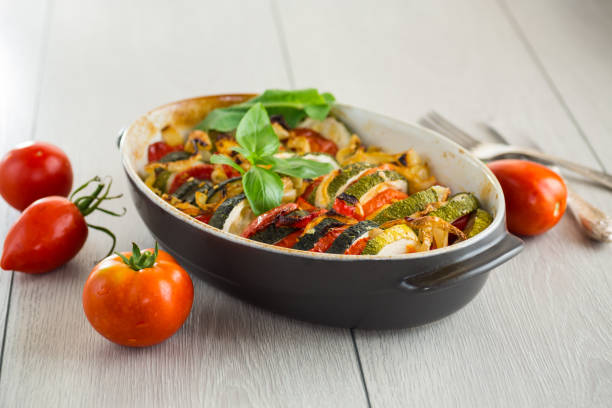 istock prepared baked zucchini and tomatoes in circles in a ceramic form, vegetable snack 2171275171