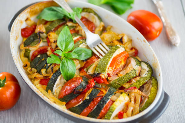 istock prepared baked zucchini and tomatoes in circles in a ceramic form, vegetable snack 2171275213