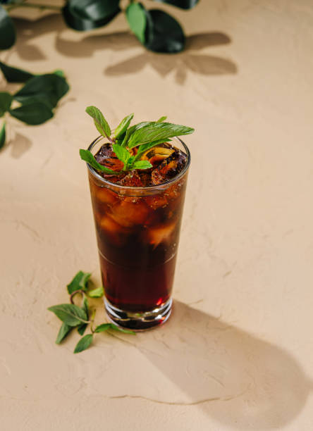 istock Refreshing dark cocktail standing on table with fresh mint leaves 2171275320