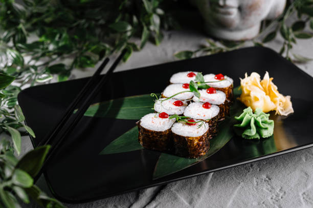 istock Sushi rolls set served on black plate with wasabi and ginger 2171275427