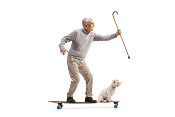 istock Elderly man with a cane riding a longboard with a dog 2171278573