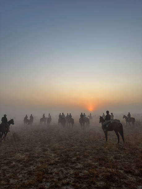 istock Horseback Safari Riders in Misty Sunrise 2171282011
