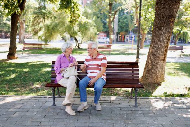 istock Couple having quiet conversation on a city bench 2171283025