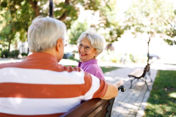 istock An elderly couple sitting on the city bench 2171283426