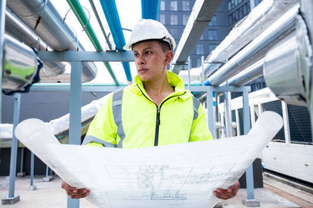 istock The technician carefully inspecting a section of pipeline during a construction project, emphasizing safety and precision in infrastructure development. 2171287325