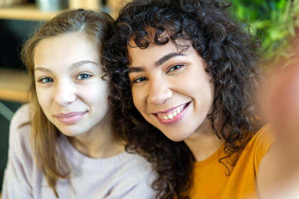 istock Happy multiethnic friends making faces and posing for taking self pictures, enjoying time together. 2171289099