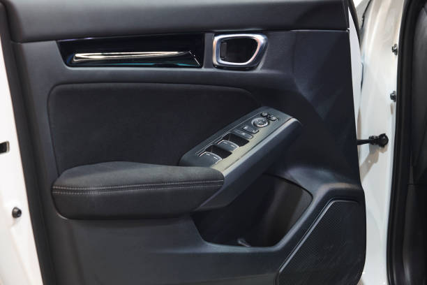istock Car interior door panel detail. Door handle and mirror control 2171290400