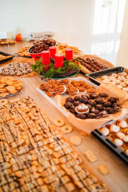 istock Multiple Batches of Cookies Macroons Biscuites and Pastry Placed on the Bakery Kitchen Table Top Fresh from the Oven on Christmas Advents 2171293355