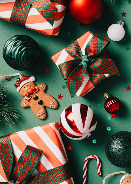 istock Vintage Christmas decorations and gifts on a green background. Includes gingerbread man, candy cane, and ornaments in red, white, and green 2171293797