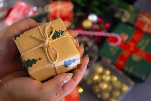 istock female hands holding a christmas gift 2171294754