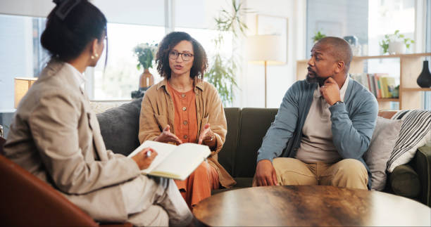 istock Couple, therapy and conversation with notes on sofa for marriage counseling, communication or support. Consulting, service and therapist with book for marital issues, advice and conflict resolution 2171295026