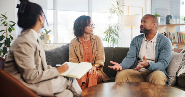 istock Couple, therapy and discussion with notes in office for marriage counseling, communication and support. Consultation, service and therapist with book on sofa for marital guidance, conflict and advice 2171295030