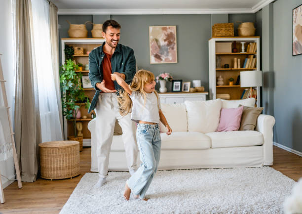 istock Dad and little daughter dancing at home 2171296121