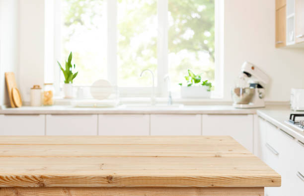 istock Empty wood table top view for product display montage on blur kitchen counter and wide window background 2171303561
