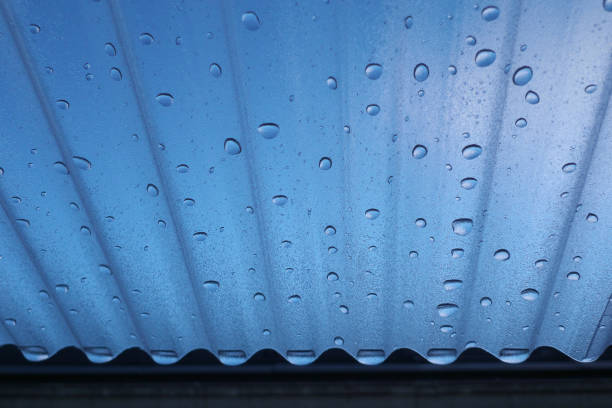 Corrugated plastic roof and water droplets with blue sky background
