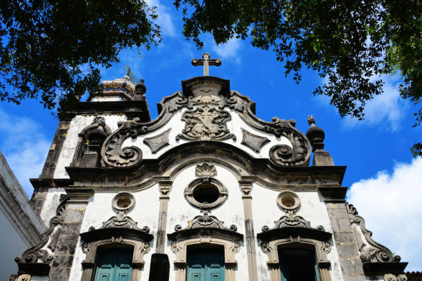 Recife, Pernambuco, Brazil: the Saint Anthony Convent (Convento de Santo Antônio) is a historic Franciscan complex founded in the early 17th century, making it one of the oldest religious sites in the city. Located in the Santo Antônio neighborhood, the convent is renowned for its Baroque architecture and houses the Golden Chapel (Capela Dourada), a masterpiece of colonial religious art adorned with gilded woodwork, intricate carvings, and ornate azulejo tiles. The convent played a key role in the religious and social life of colonial Recife and continues to be a significant cultural and religious site, attracting visitors for its historical and artistic importance. Portuguese colonial architecture.