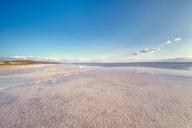 Salt lake landscape. Large empty nature area. A few clouds above the horizon. Natural salt mineral source