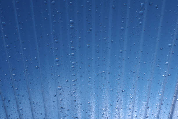 Corrugated plastic roof and water droplets with blue sky background