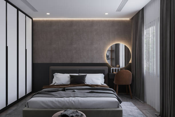 istock A spacious minimalist bedroom highlighting a monochrome black bed with a plush, quilted headboard. 2171306575