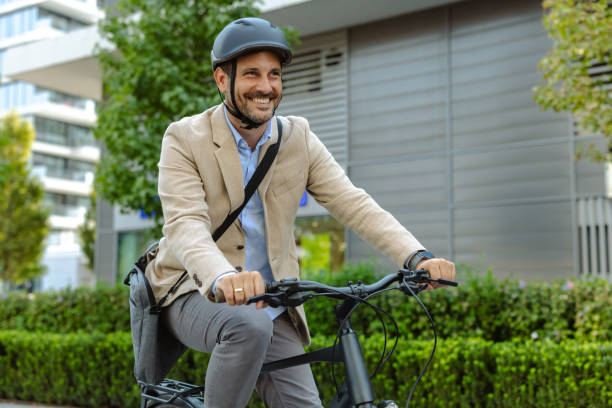 istock Smiling businessman commuting to work on a bicycle 2171307554