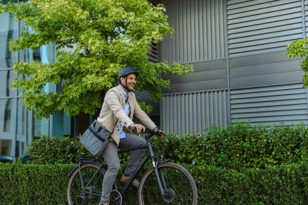 istock Smiling businessman commuting by bicycle in urban environment 2171307687