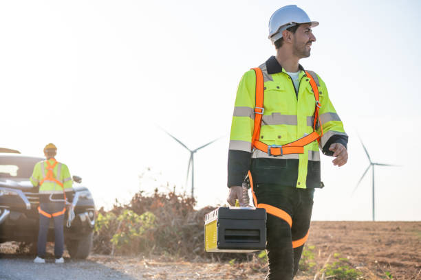 istock Caucasian male technician walking outdoors in the wind turbines field. Innovation engineer wearing safety gear, working to develop environmental renewable clean energy at windmill farm in rural area. 2171307937