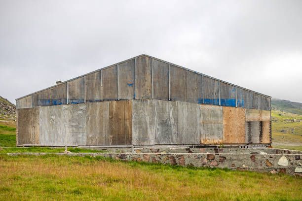 Igaliku, Greenland, Denmark - August 14nd 2024: Old barn in the small city which has been a major place for farming, but today is mostly known as a tourist town and some the houses are being converted into summerhouses. The footing is built of stones which are very unusual in Greenland. A major part of the stones originate from the Gadar ruins, which are remains from the Norsemen who lived here until their disappearance in the beginning of the 15th century.