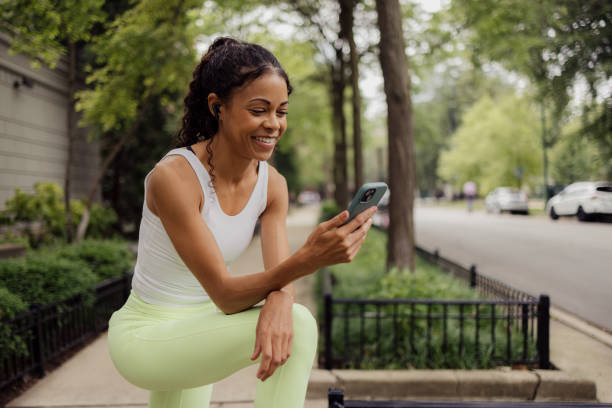 istock Happy black athlete using cell phone on the street. 2171310109