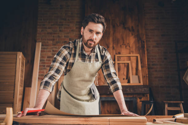 istock Photo of professional builder guy open scheme working on building plan garage indoors 2171311406