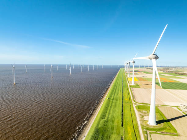 istock Wind turbines in lakeshore wind park producing electricity during springtime 2171312554