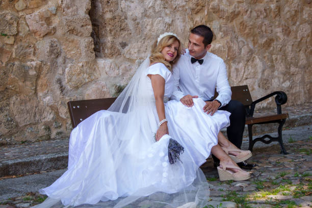 bride and groom on swing kissing.