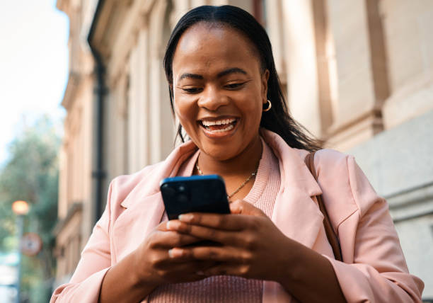 istock Confident Black Business Woman Smiling While Using Smartphone in Urban City Setting 2171313398
