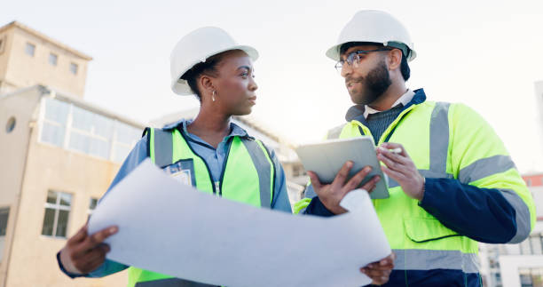 istock Business people, architect and team with blueprint for construction, planning or building maintenance in city. Contractor, civil engineer or colleagues with technology or document for architecture 2171314761