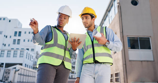 istock Tablet, blueprint and construction engineers on rooftop site for city planning, renovation or building project. Digital technology, architecture and industrial civil employees with maintenance check. 2171314778