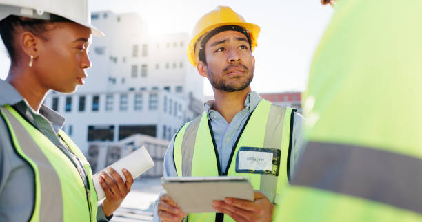 istock Tablet, group and construction engineers on site for city planning, maintenance or repairs. Discussion, contractor and team of civil employees with technology for renovation approval on town rooftop. 2171314788