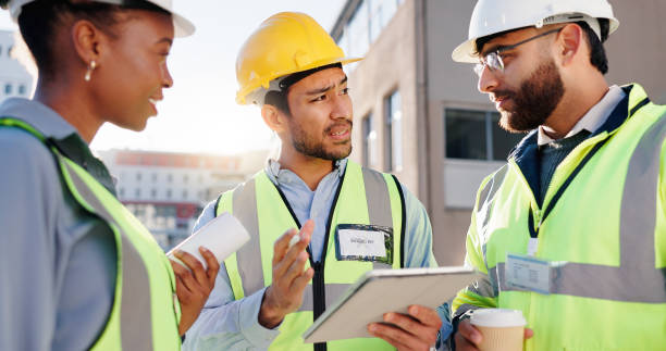 istock Tablet, engineering and construction team on site for city planning, maintenance or repairs. Discussion, contractor and group of civil employees with tech for renovation approval on town rooftop. 2171314792