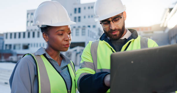 istock Team, tech or planning construction on rooftop for building maintenance, civil engineer or discussion. Contractors, laptop or project management in city with architect for infrastructure development 2171314800