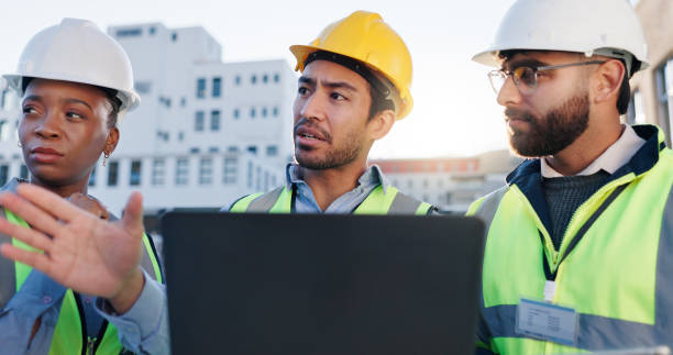 istock Laptop, group and construction engineers on site for city planning, maintenance or repairs. Discussion, contractor and team of civil employees with technology for renovation approval on town rooftop. 2171314814