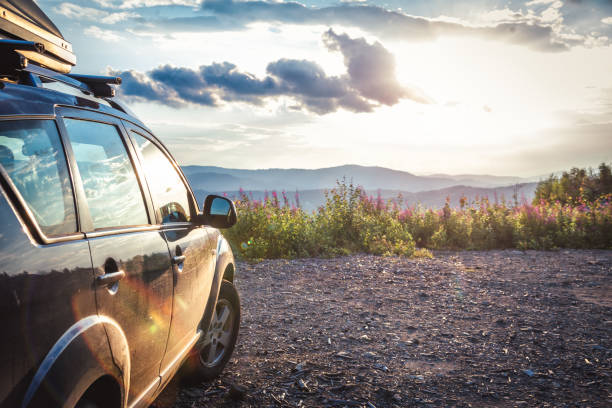 car for traveling with a mountain road. Blue sky